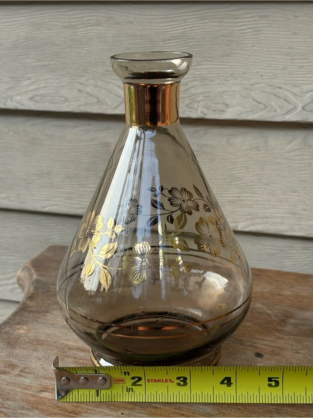 Art Deco decanter set features smoky purple glass adorned with a gold floral